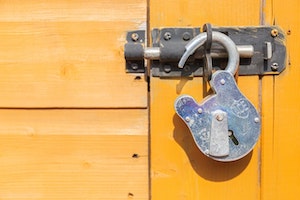 Picture of an unlocked (open) padlock on a door